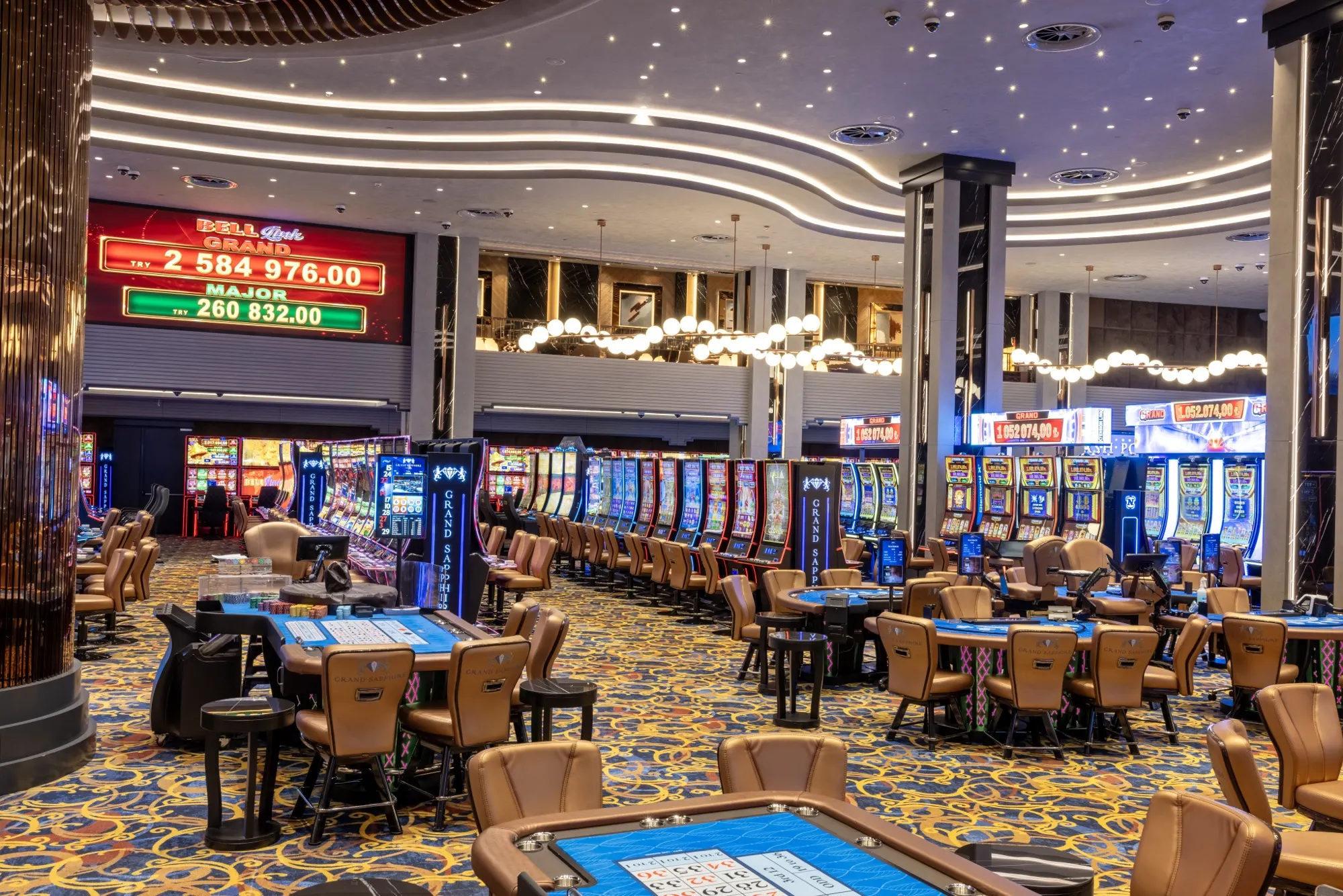Casino hall with gaming tables and slot machines under a starry ceiling