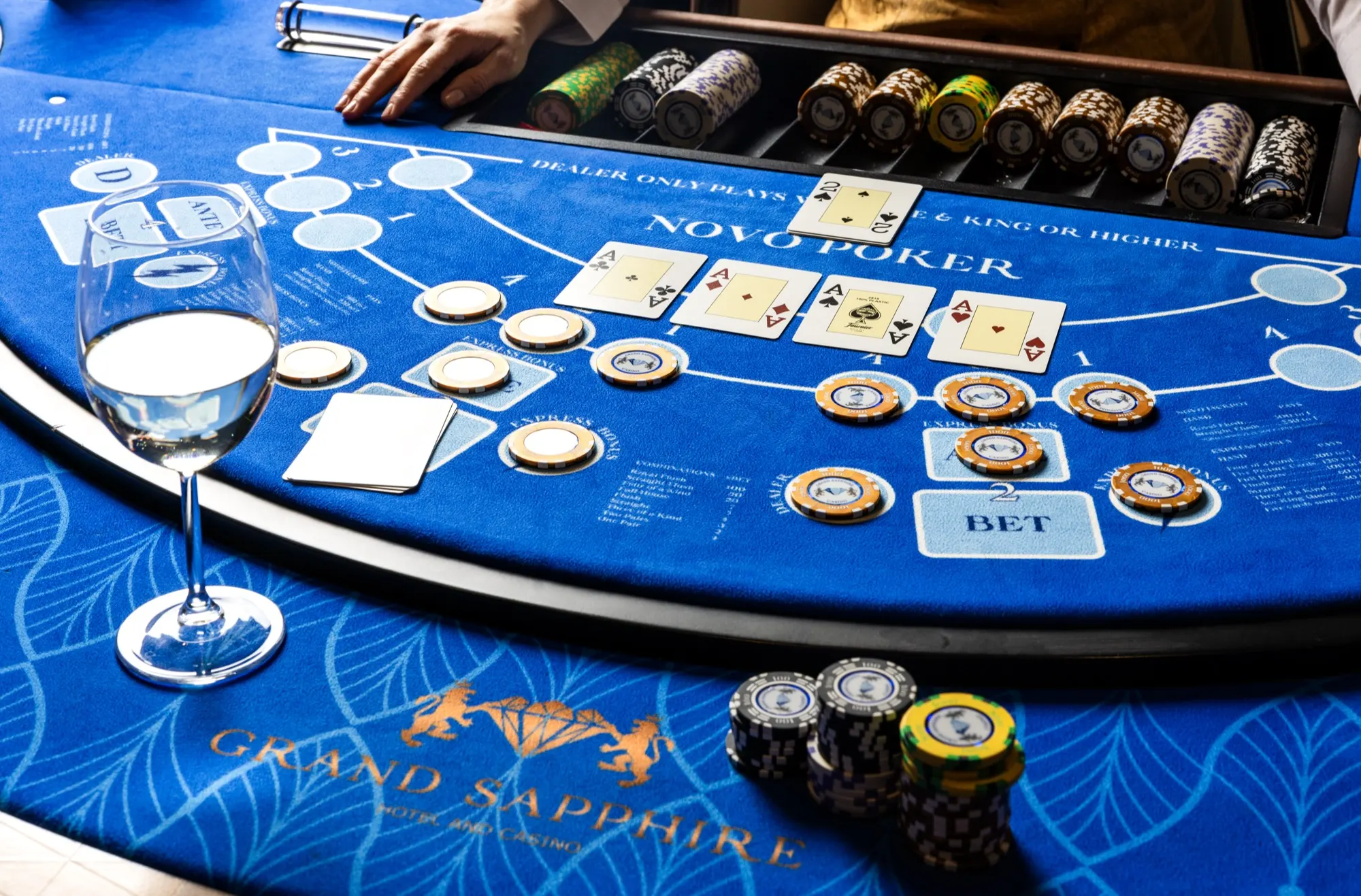 Novo Poker table with chips, cards and the Grand Sapphire logo